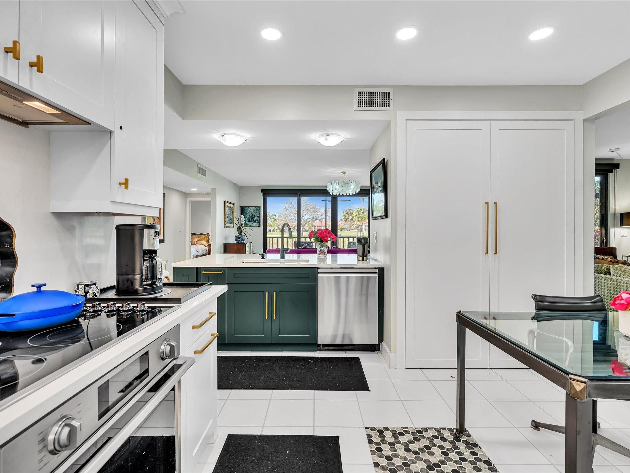 7642 Elm Ridge Drive, Unit 14L Boca Raton, FL 33433 - Photo 20 of 69 a kitchen with a stove and a refrigerator