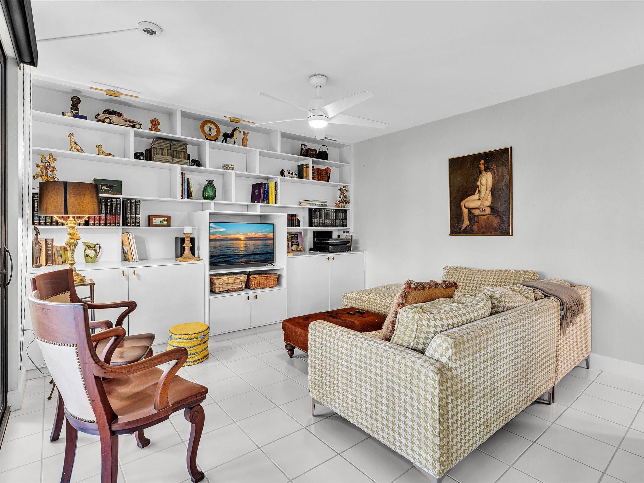 7642 Elm Ridge Drive, Unit 14L Boca Raton, FL 33433 - Photo 25 of 69 a living room with furniture and a flat screen tv