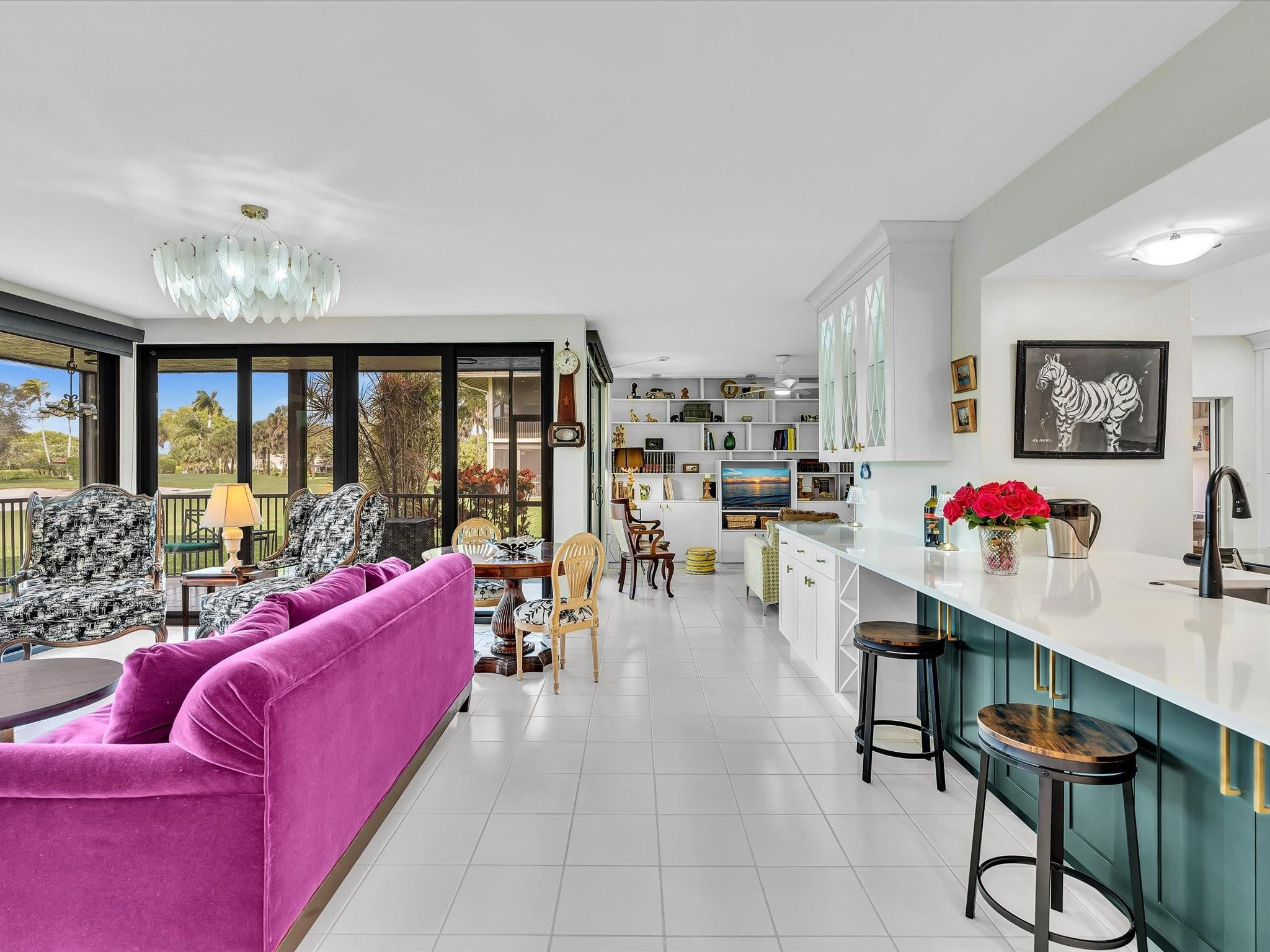7642 Elm Ridge Drive, Unit 14L Boca Raton, FL 33433 - Photo 27 of 69 a living room with furniture large window and kitchen view
