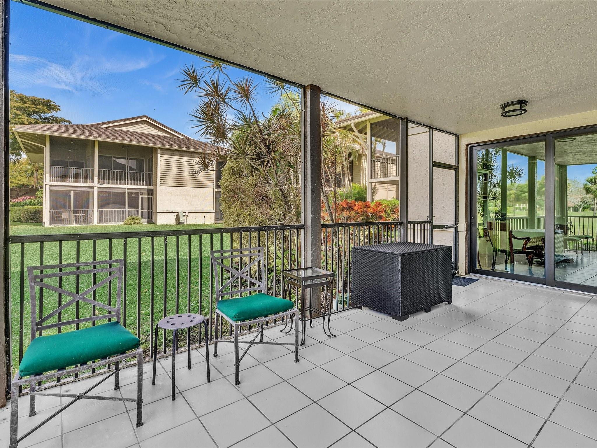 7642 Elm Ridge Drive, Unit 14L Boca Raton, FL 33433 - Photo 34 of 69 a view of a chairs and table in a back yard of the house