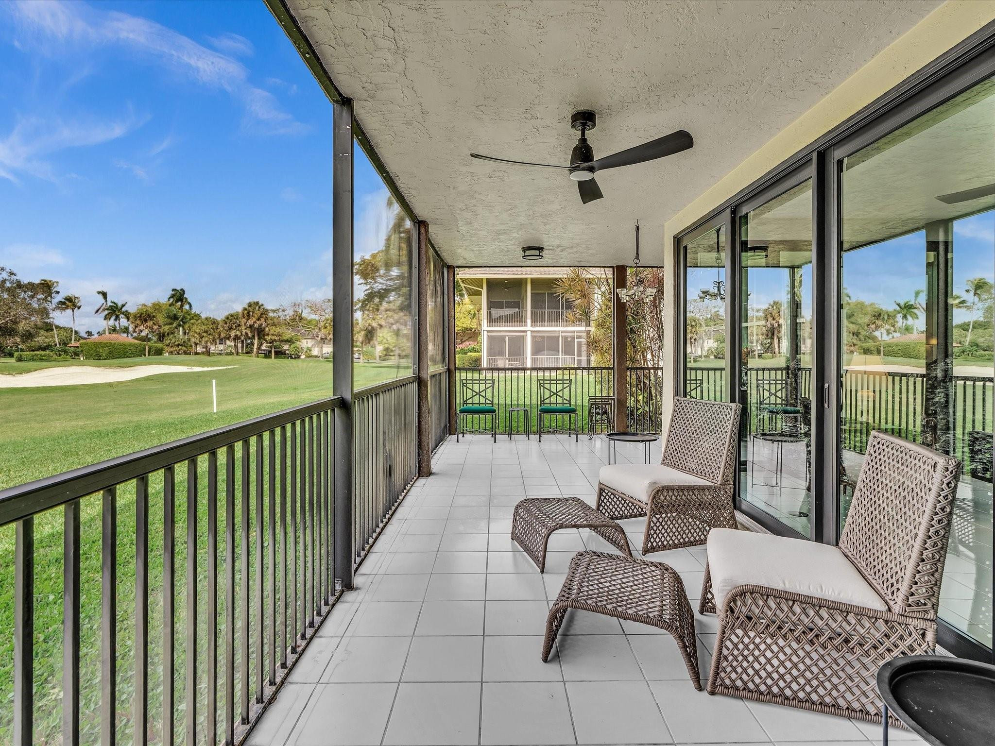 7642 Elm Ridge Drive, Unit 14L Boca Raton, FL 33433 - Photo 40 of 69 a view of a chair and tables in the balcony