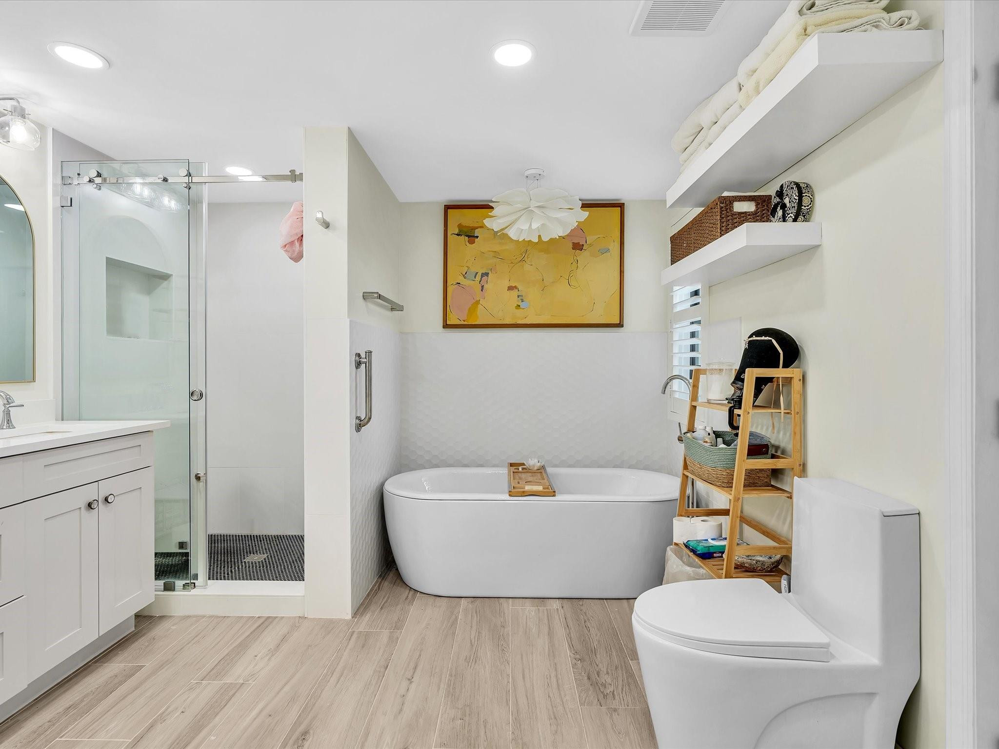 7642 Elm Ridge Drive, Unit 14L Boca Raton, FL 33433 - Photo 49 of 69 a bathroom with a sink a bathtub a mirror a toilet and a shower