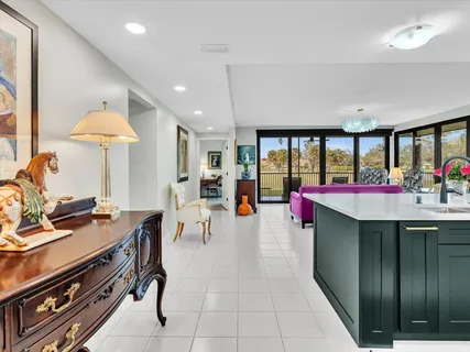 a living room with furniture and large windows