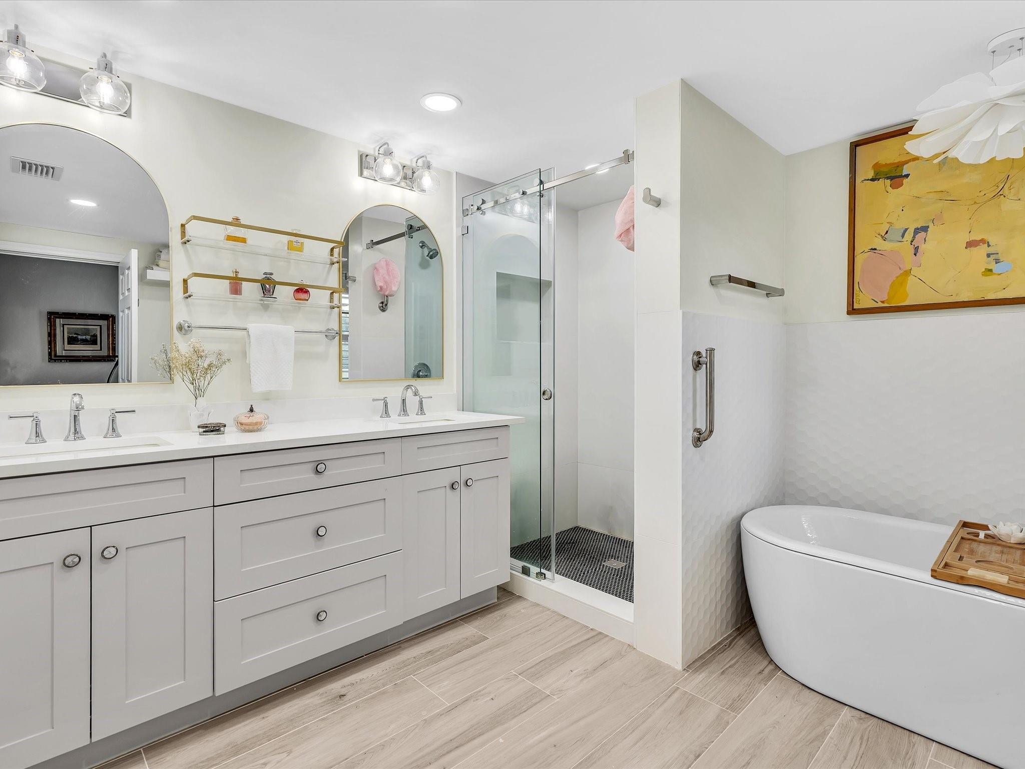7642 Elm Ridge Drive, Unit 14L Boca Raton, FL 33433 - Photo 51 of 69 a spacious bathroom with a double vanity sink a mirror a shower and a bathtub