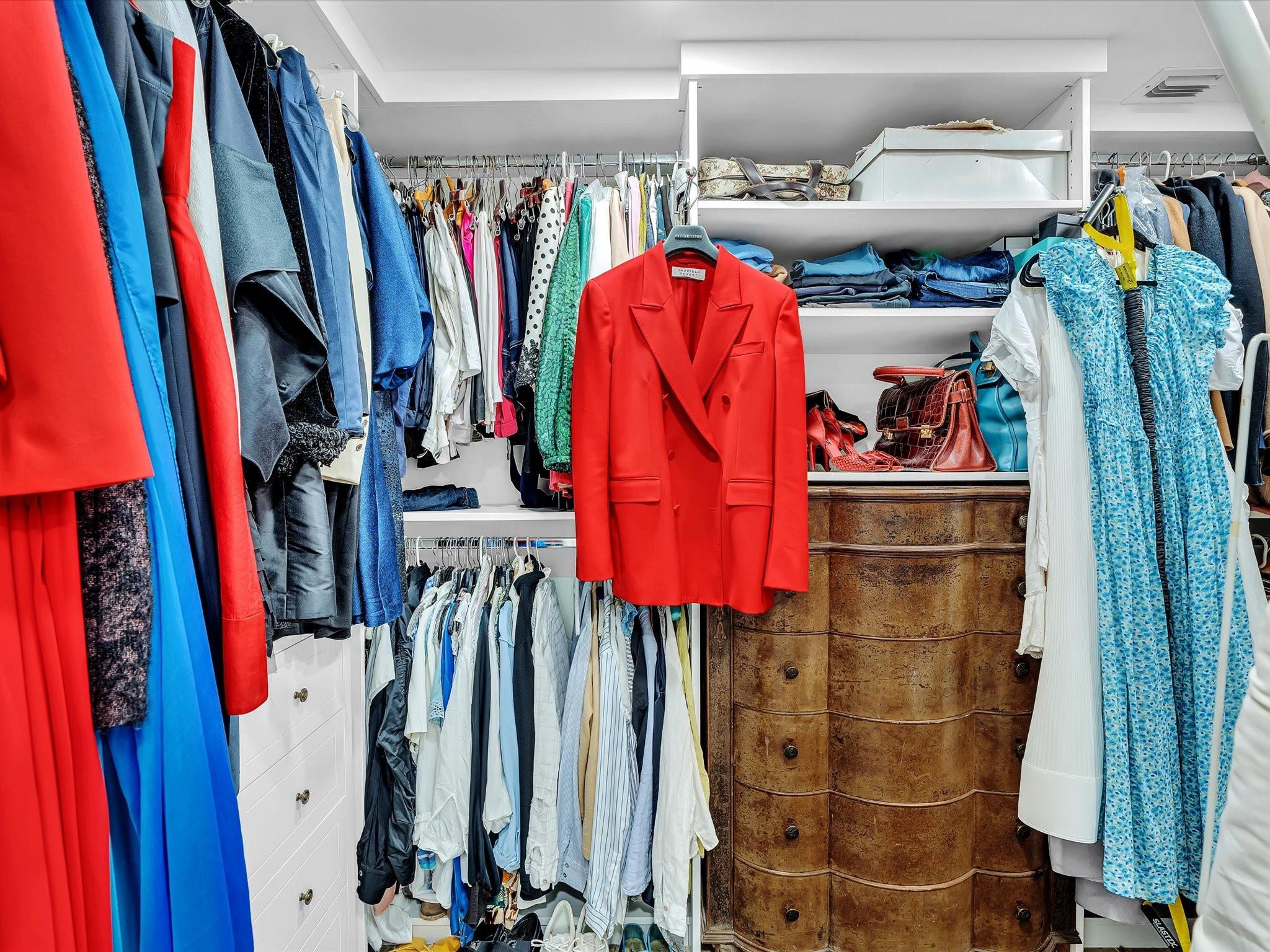7642 Elm Ridge Drive, Unit 14L Boca Raton, FL 33433 - Photo 53 of 69 a view of walk in closet with clothes and shoes