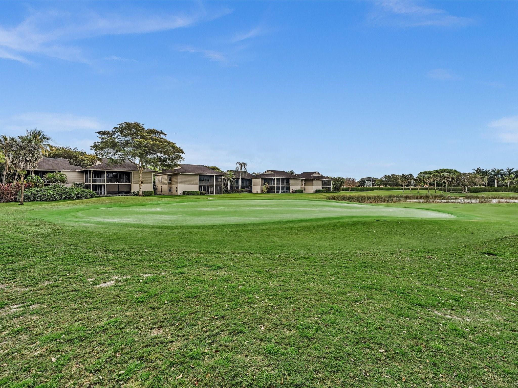 7642 Elm Ridge Drive, Unit 14L Boca Raton, FL 33433 - Photo 60 of 69 a view of a grassy field with an trees