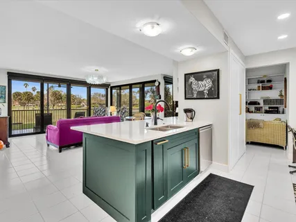 a kitchen with granite countertop a sink stove and white cabinets