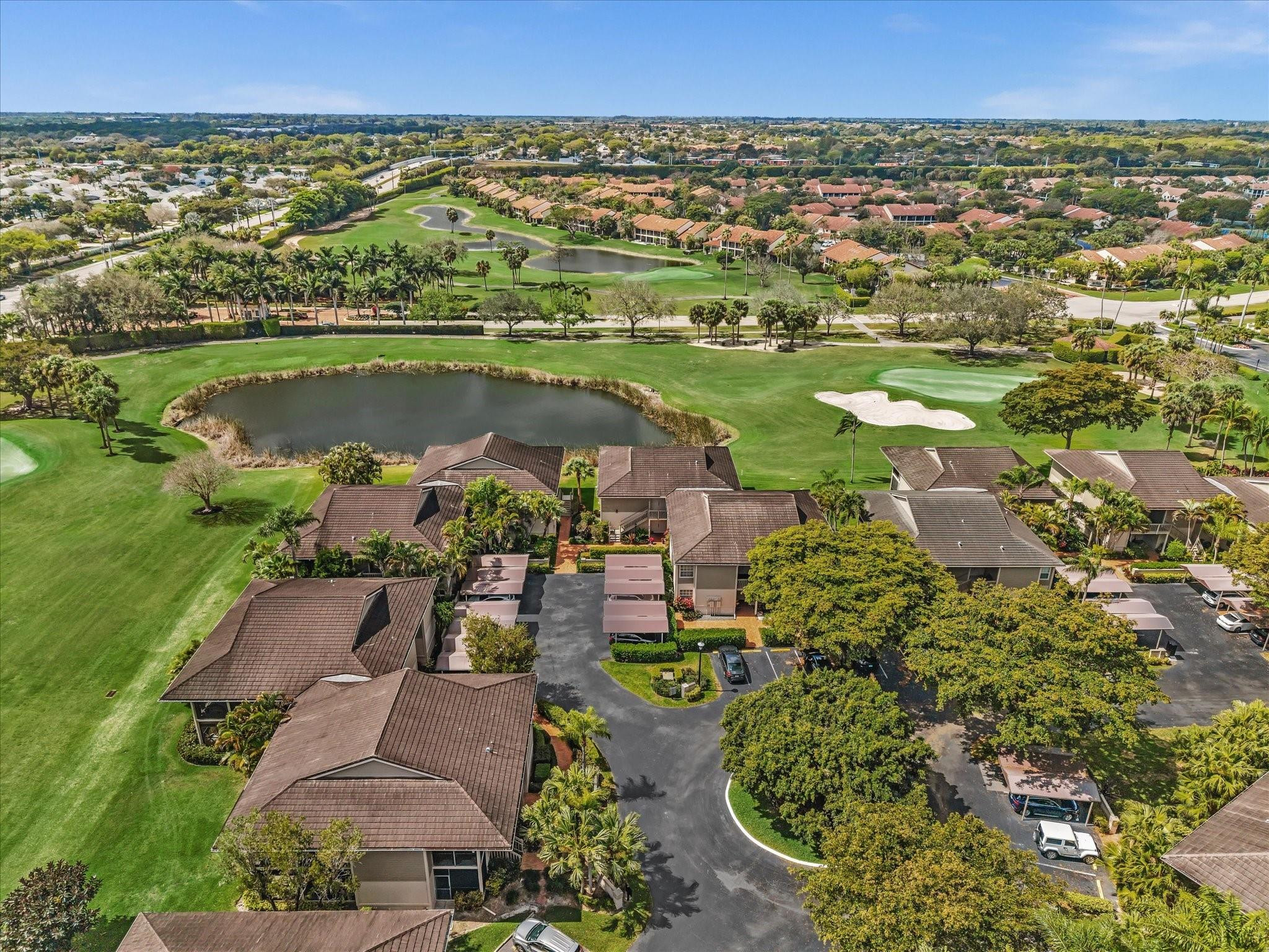 7642 Elm Ridge Drive, Unit 14L Boca Raton, FL 33433 - Photo 62 of 69 an aerial view of a house with a lake view