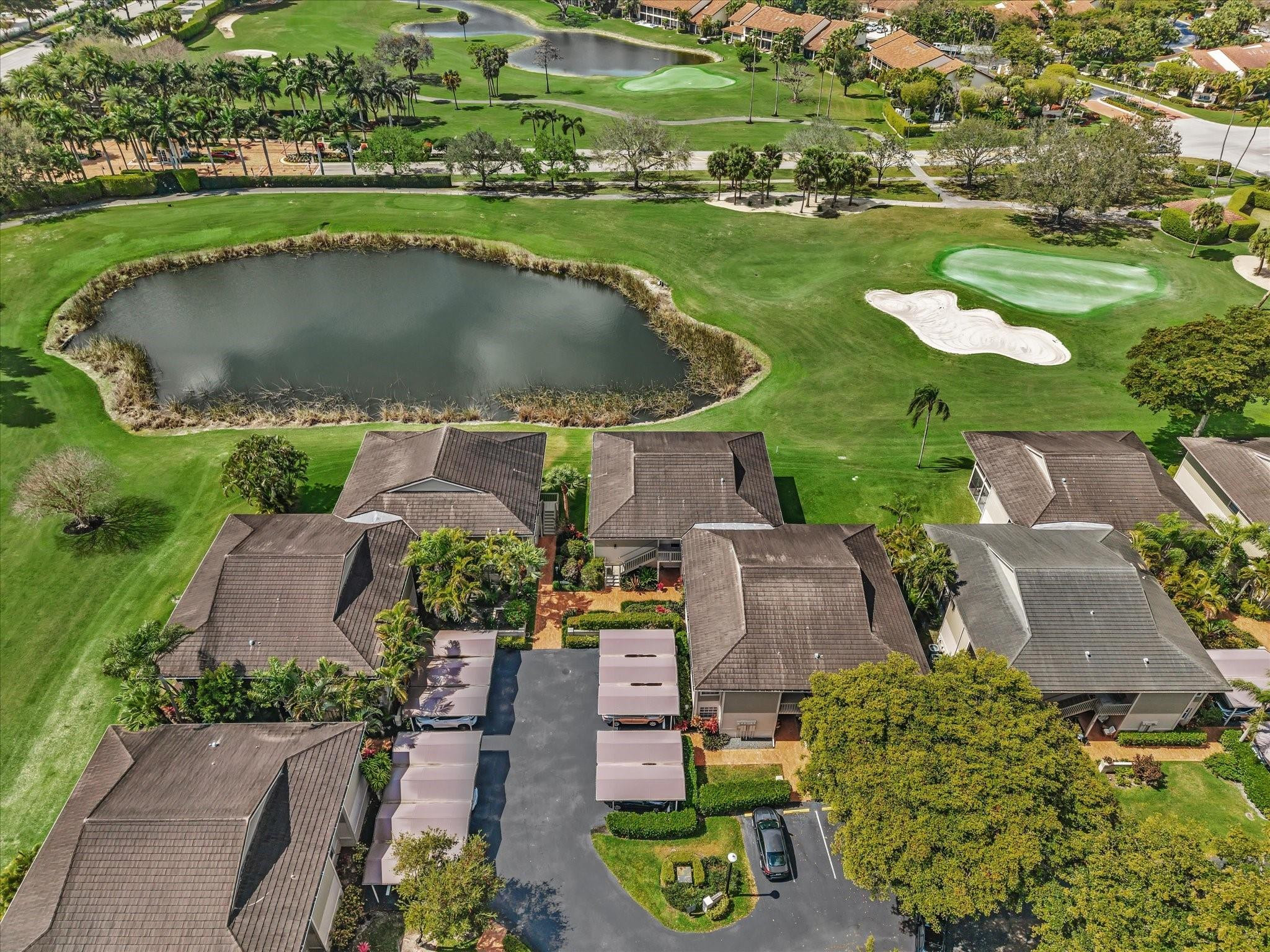 7642 Elm Ridge Drive, Unit 14L Boca Raton, FL 33433 - Photo 63 of 69 an aerial view of a house with a garden and lake view