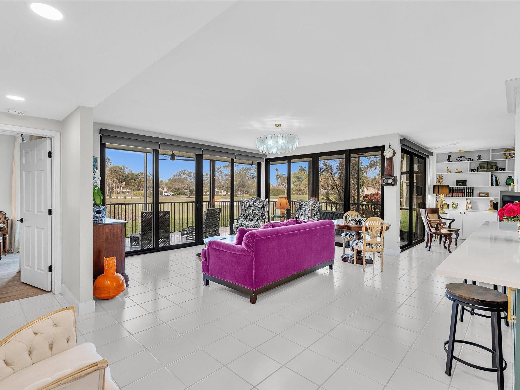 7642 Elm Ridge Drive, Unit 14L Boca Raton, FL 33433 - Photo 7 of 69 a living room with furniture and large windows