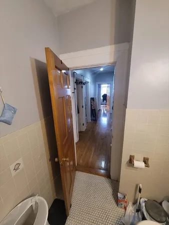 a view of a hallway to a livingroom with furniture