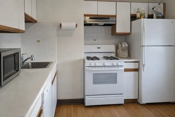 a kitchen with a stove and a refrigerator