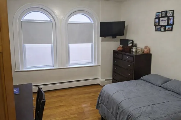 a bedroom with a bed and a flat screen tv
