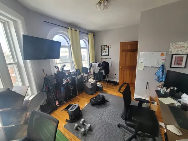 a view of a workspace with furniture and a window