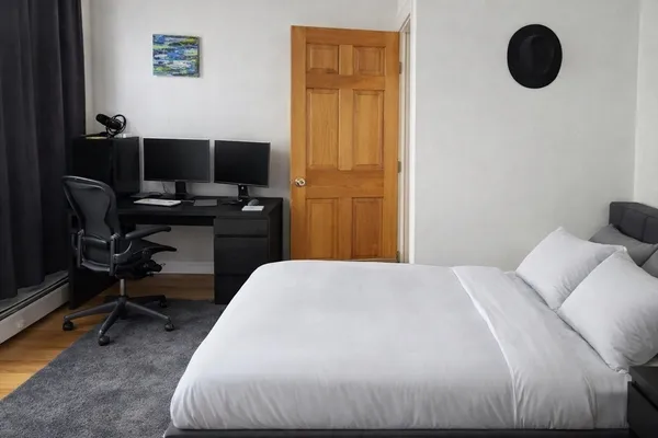 a bedroom with a bed and a chair
