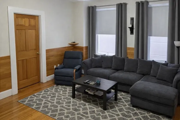 a living room with furniture and a rug