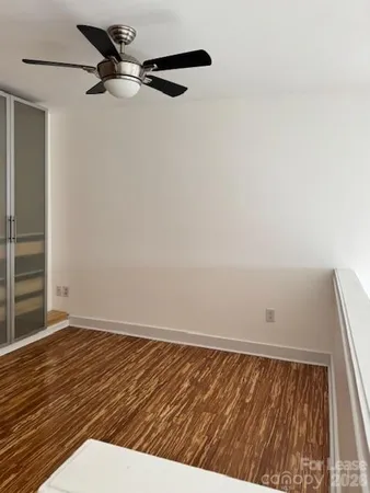a view of a balcony with wooden fence and floor