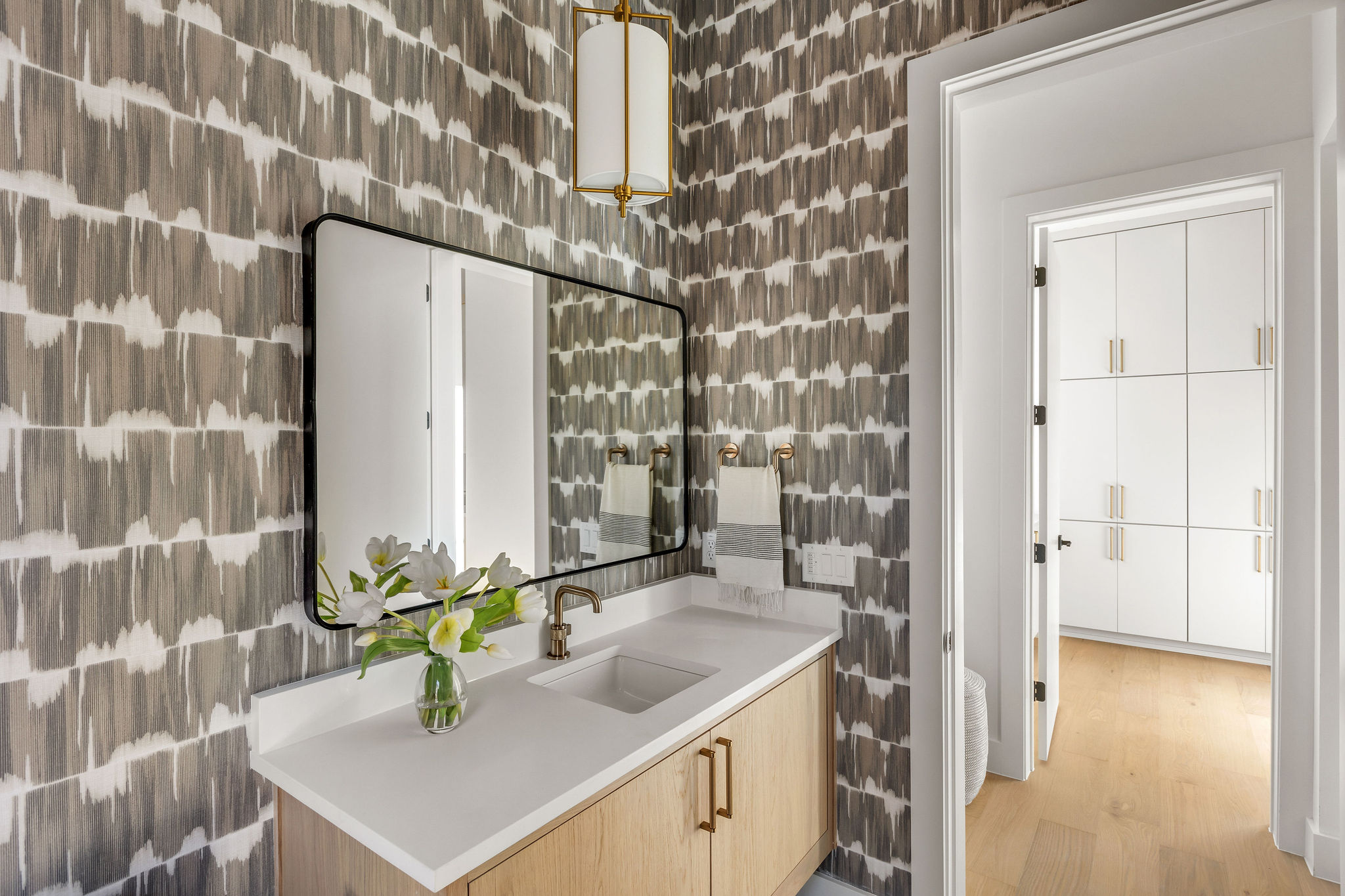 8307 Silver Ridge Drive Austin, TX 78759 - Photo 12 of 27 Bar area with light wood finish cabinetry, light countertops, tile walls, and light wood finished floors