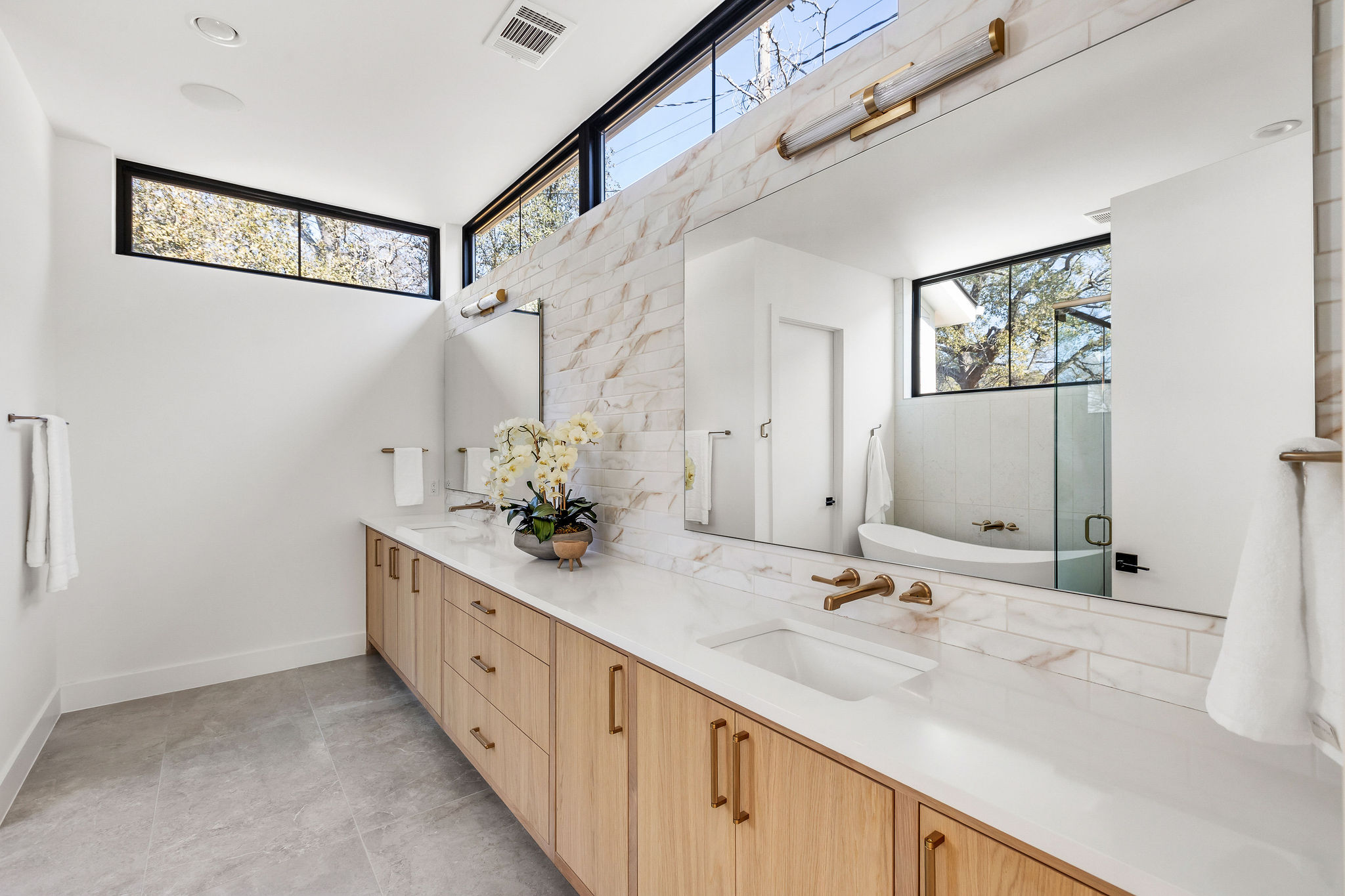 8307 Silver Ridge Drive Austin, TX 78759 - Photo 14 of 27 Bathroom featuring double vanity, a freestanding bath, healthy amount of natural light, and a shower with door