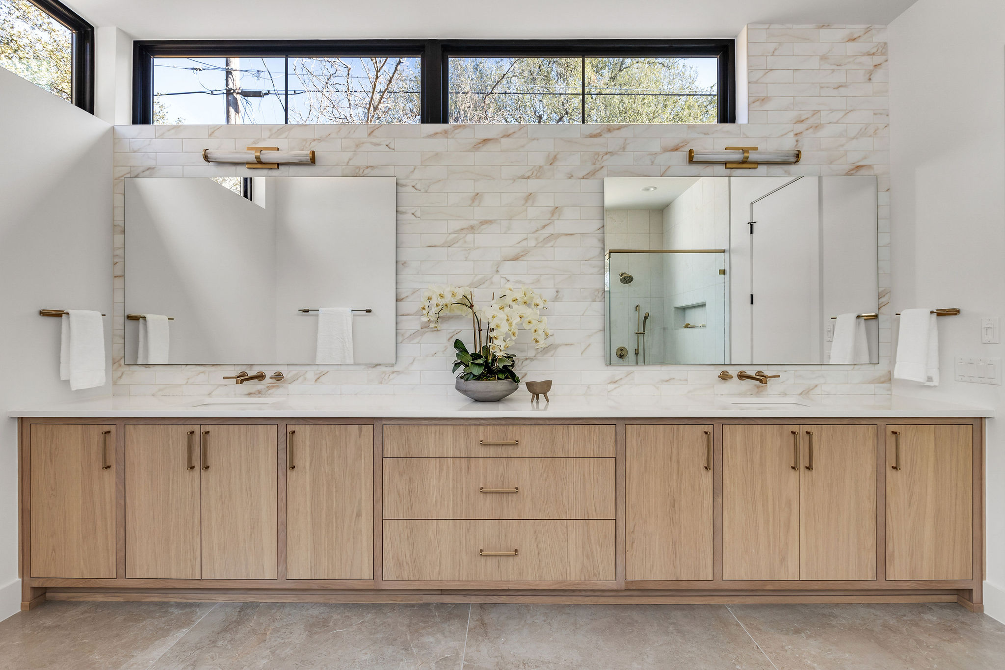 8307 Silver Ridge Drive Austin, TX 78759 - Photo 15 of 27 Bathroom with a shower stall, double vanity, and decorative backsplash
