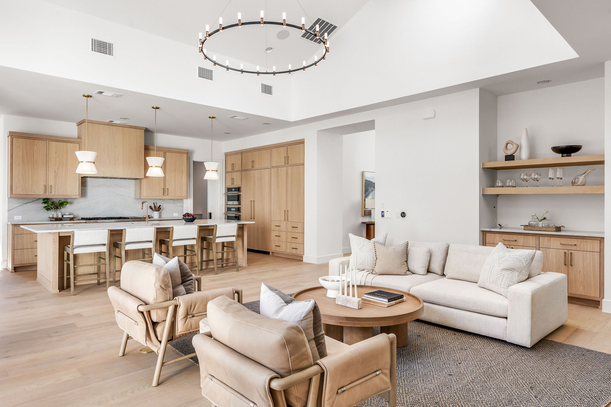 8307 Silver Ridge Drive Austin, TX 78759 - Photo 3 of 27 Living room featuring light wood finished floors, a high ceiling, and hanging lights