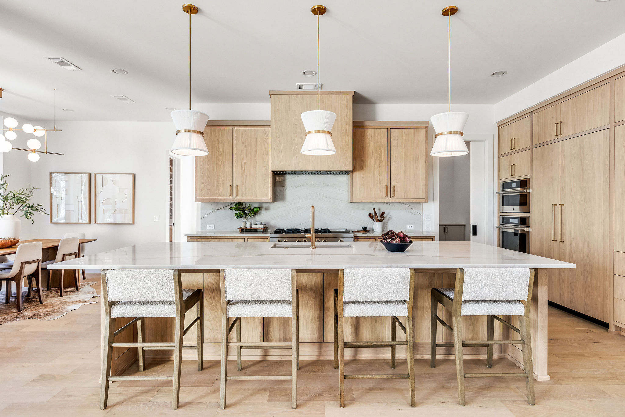 8307 Silver Ridge Drive Austin, TX 78759 - Photo 6 of 27 Kitchen featuring light wood finish cabinetry, light wood-style floors, decorative light fixtures, and light stone counters