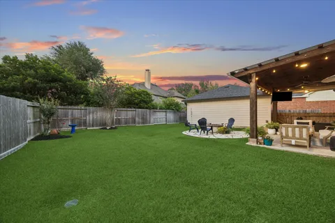 a view of a backyard with sitting area