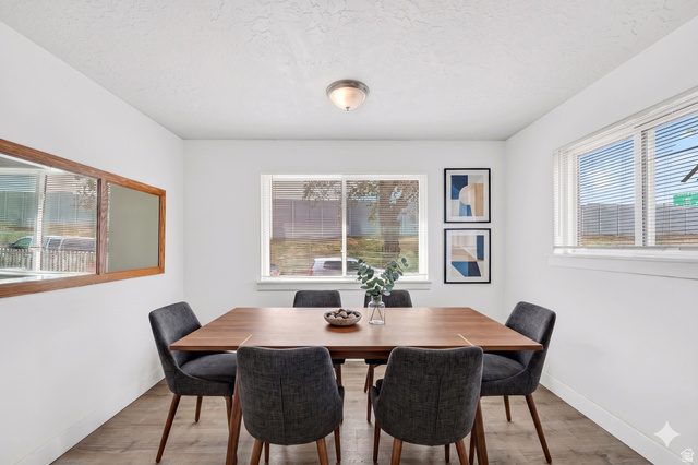 7879 Oak Street Midvale, UT 84047 - Photo 9 of 32 Bright dining area featuring wood-finish flooring, white walls, and a ceiling-mounted light fixture