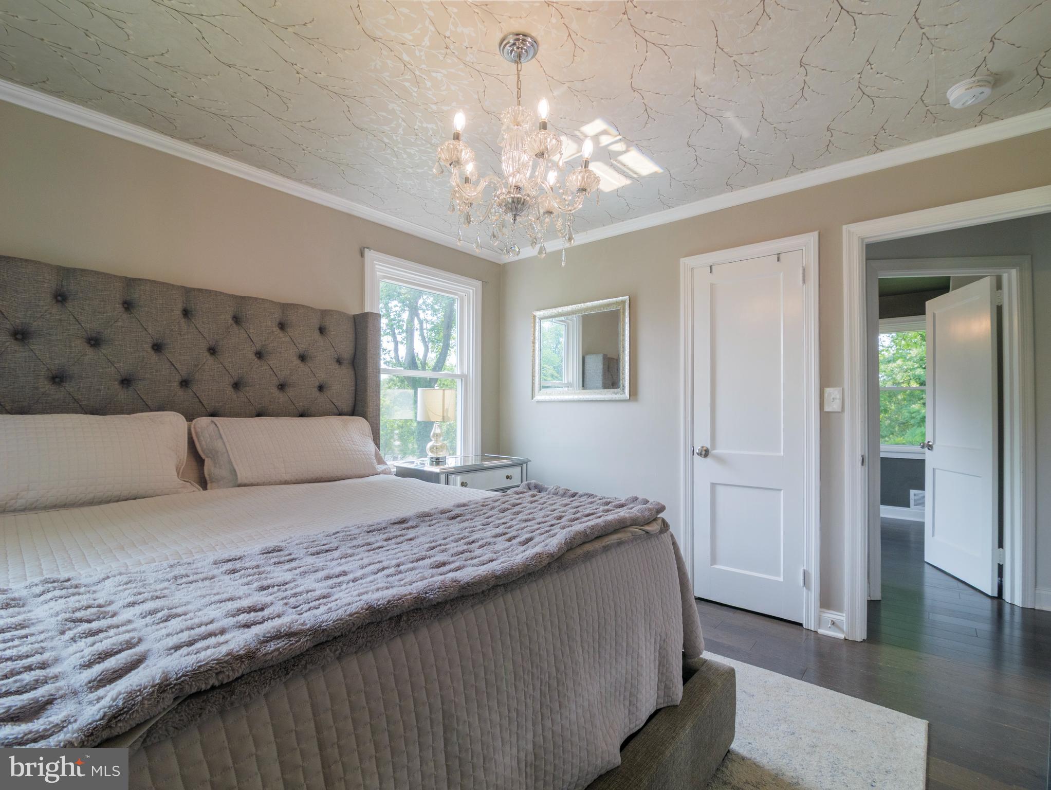 2509 Mason Street Silver Spring, MD 20902 - Photo 14 of 26 a bedroom with a large bed and a chandelier