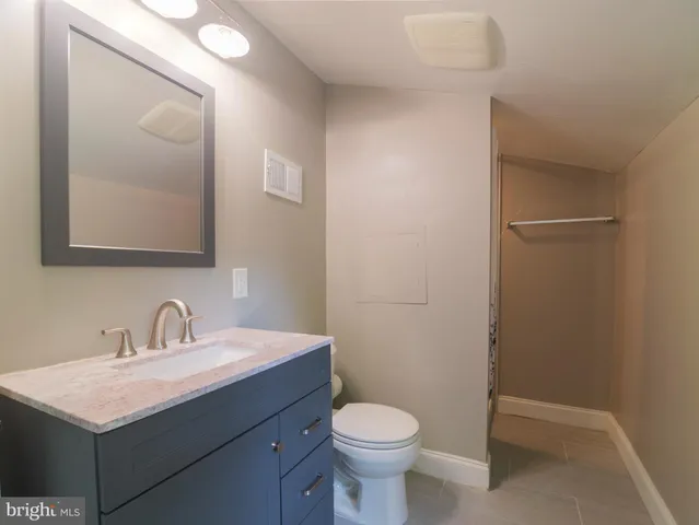 a bathroom with a sink toilet and mirror