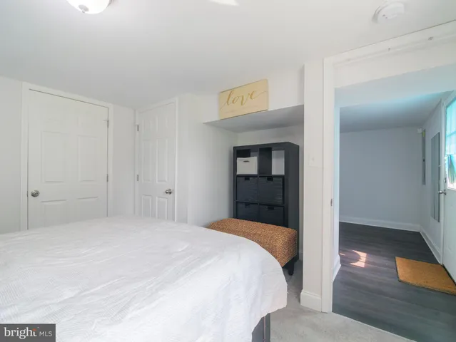 a bedroom with a bed and a view of en suite bathroom