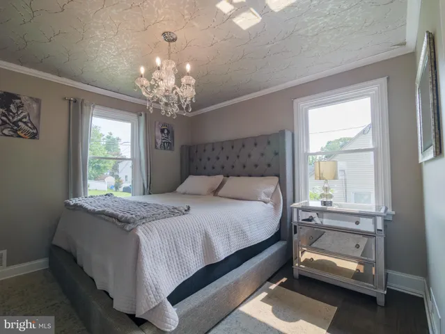 a bedroom with a bed and a chandelier