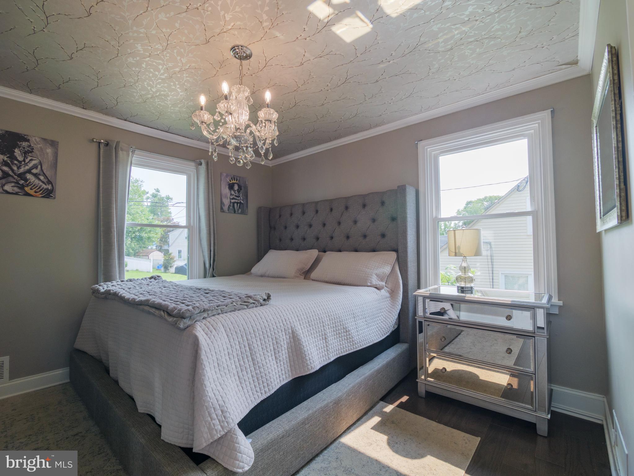 2509 Mason Street Silver Spring, MD 20902 - Photo 8 of 26 a bedroom with a bed and a chandelier