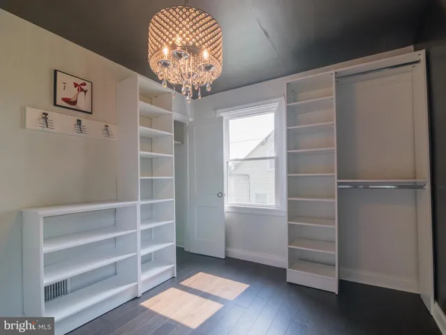 a view of room with window and wooden floor