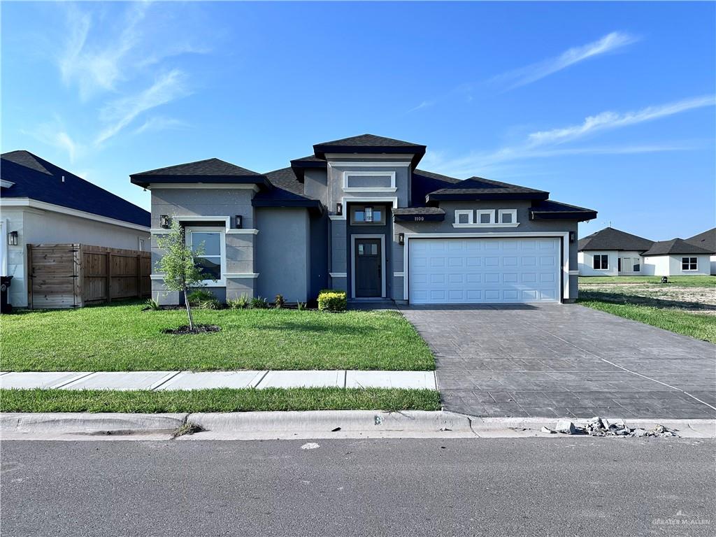 1100 Azalea Street Mission, TX 78573 - Photo 2 of 24 a front view of a house with a garden