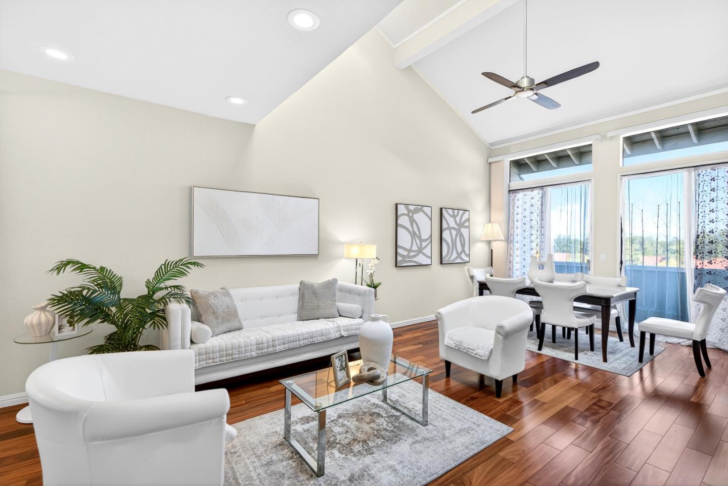 a living room with furniture a wooden floor and a chandelier
