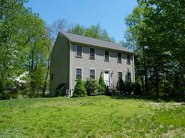 a front view of house with yard and trees