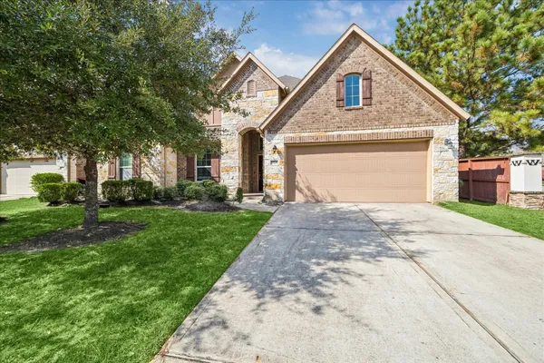 a front view of a house with a yard and garage