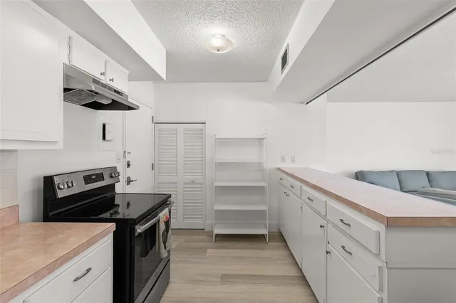 a kitchen with white cabinets and white appliances