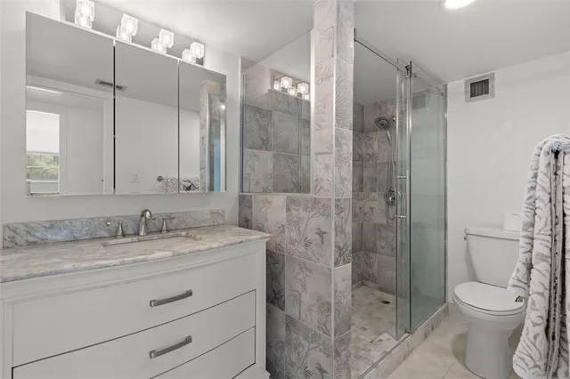 a bathroom with a toilet and a shower