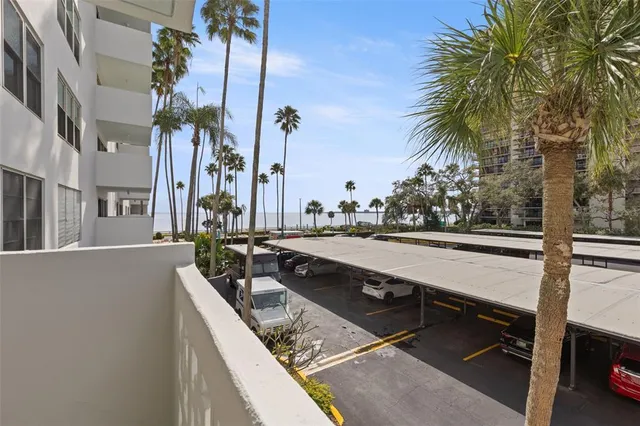 a view of a lake with couches and wooden floor