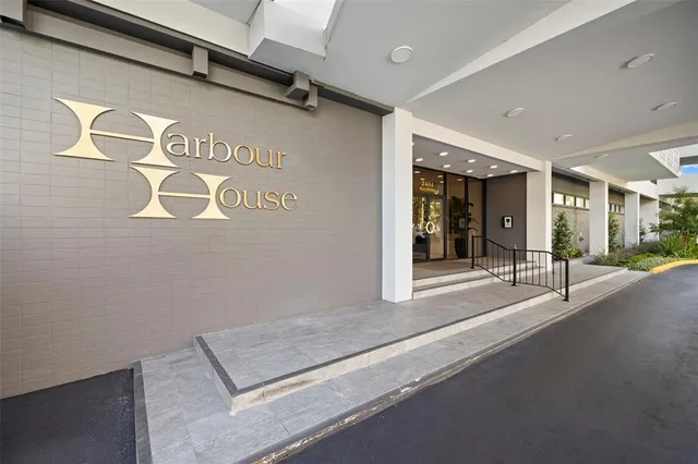 a living room with furniture kitchen and a flat screen tv