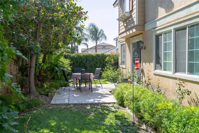 a view of a chair and table in backyard of the house