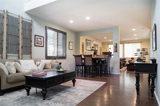 a living room with furniture wooden floor and a table