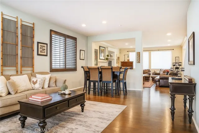 a living room with furniture wooden floor and a large window