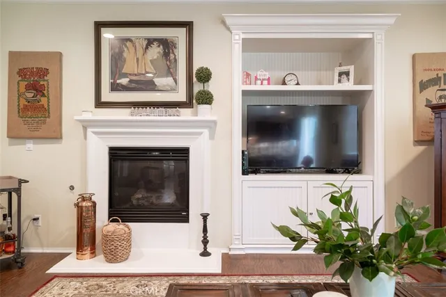 a living room with a fireplace and a flat screen tv