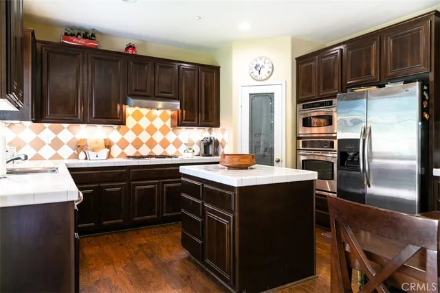 a kitchen with a sink stove and refrigerator
