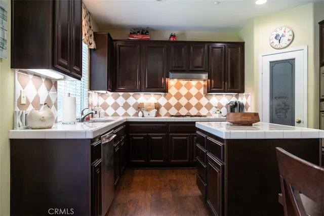 a kitchen with granite countertop a sink and cabinets