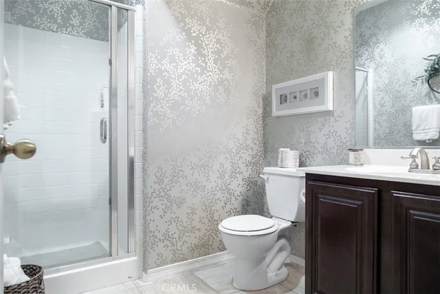 a bathroom with a toilet a sink and shower