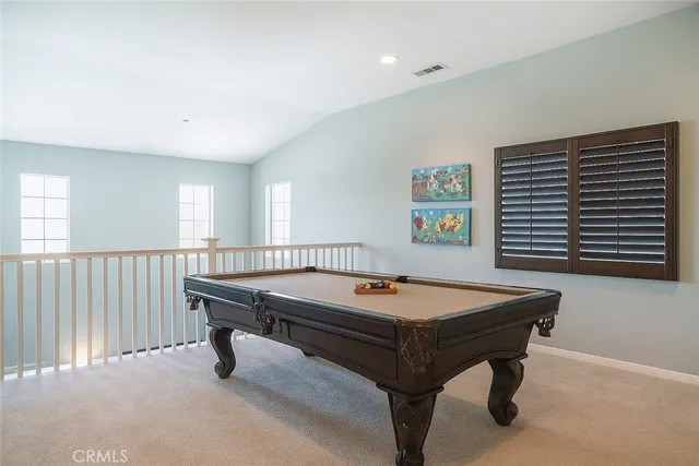 a room with pool table and windows